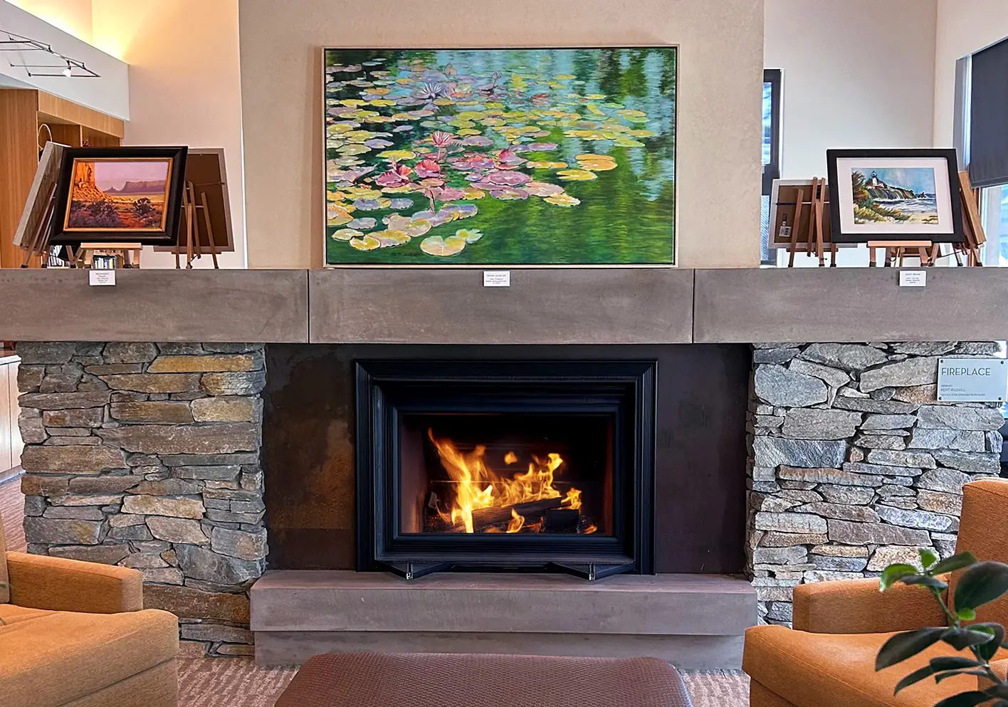 Photo of a featured painting hanging above the fireplace at Gallery Q.