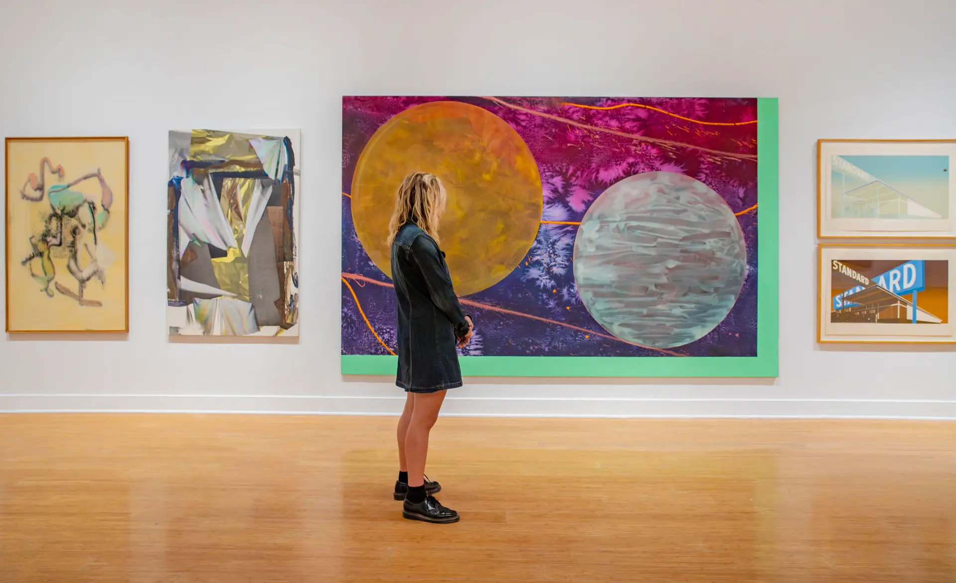 Young lady admiring a painting at the Laguna Art Museum