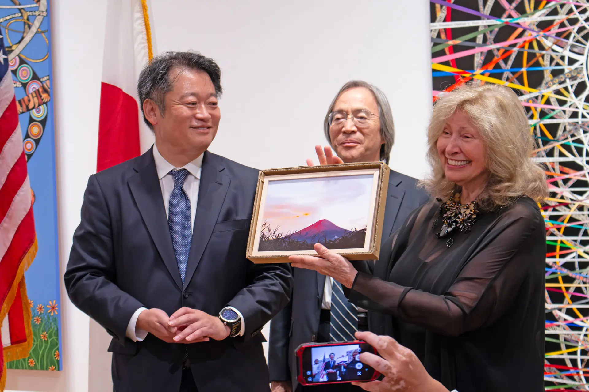 Japanese representative presenting a Mt. Fuji framed painting to a Sister Cities representative